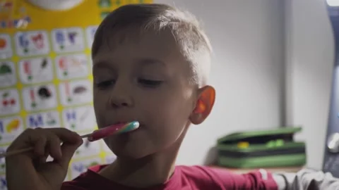 Kid eats huge candies with lollipops, close up - high sugar Stock Footage 146408413