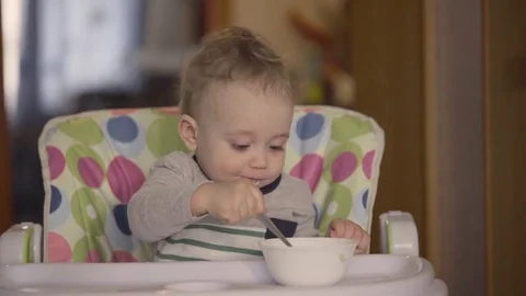 The Kid Eats With a Spoon Porridge Video stock 76132582