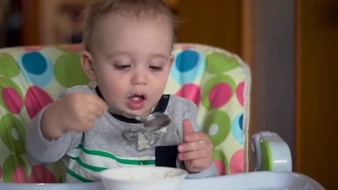 The Kid Eats With a Spoon Porridge Stock Footage 76132712