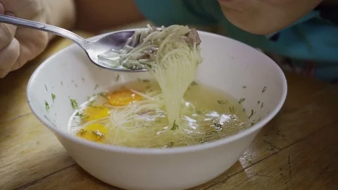 Kid eats a tasty and healthy soup in slow motion close-up Stock Footage 126292136