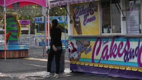 Kid at empty fair by food booth Stock Footage 154941684