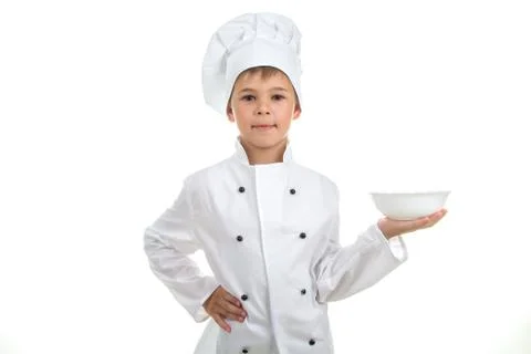 A kid with an empty plate on his hand wearing chef uniform, isolated on white Stock Photos