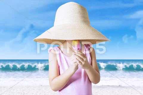 Kid enjoy ice cream while wearing hat Stock Photos