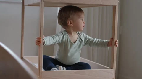 Kid exploring wooden playpen Stock Footage 301387725