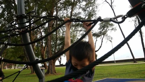 A kid with face mask try to climb the rope. Video stock 172215052