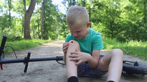 Kid fall when riding an electric scooter. Riding an e-scooter without protective Stock Footage 247360313