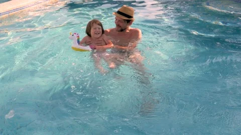 Kid father pool child swimming pool happy dad and daughter playing water summer Stock Footage 194821324