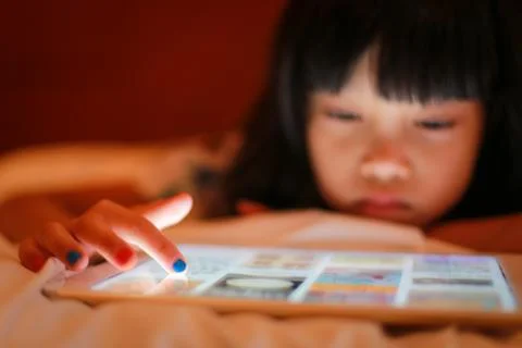 Kid finger tip touch on digital tablet device. Stock Photos