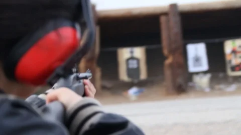 Kid fires multiple shots at target Stock Footage 113913034