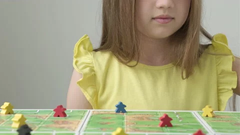 Kid girl playing in board game with colorful figures. Kids leisure concept Stock-Footage 208232553