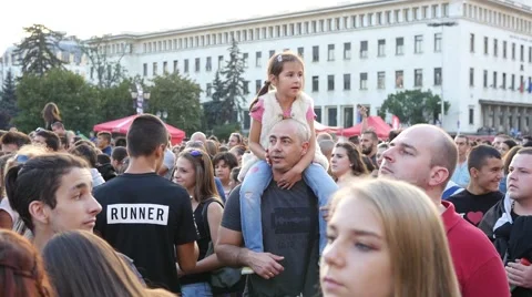 Kid girl sit on father shoulders in concert people crowd in Sofia Bulgaria Stock Footage