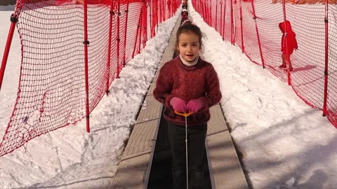Kid goes up a hill with an elevator to ski. in Erzurum mountains, Turkey Stock Footage 149880978