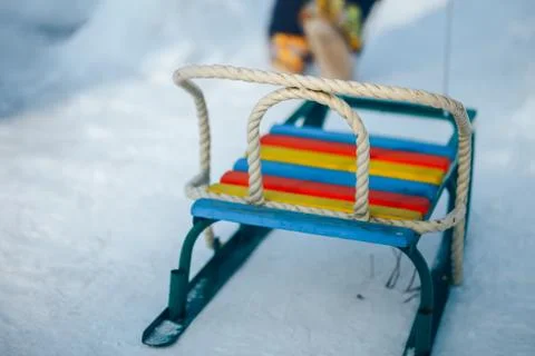 Kid going up on a hill pulling sledge. Stock Photos