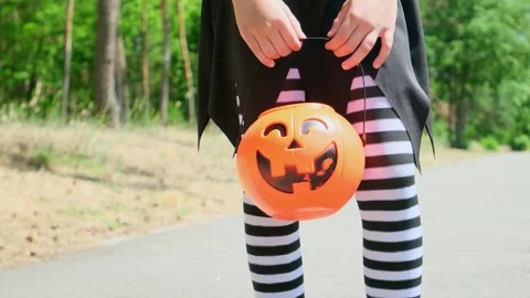 Kid going trick or treating. Low section shot of child in festive Halloween cost Stock Footage 279317604