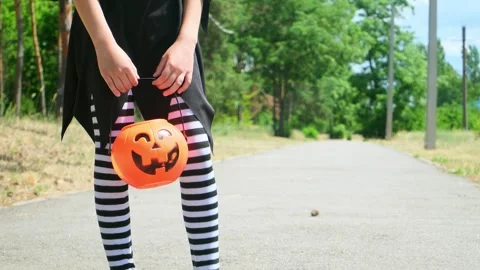 Kid going trick or treating. Low section shot of child in festive Halloween cost Stock Footage 279874279