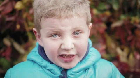 Kid goofing around looking to camera. Little boy feeling angry Stock Footage 141612514