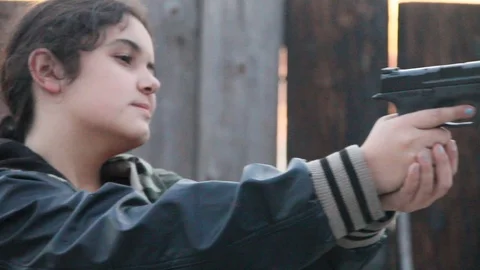 Kid with gun, playing thug Stock Footage 114217042