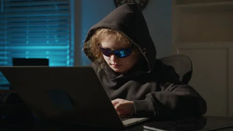 Kid hacker learning programming at home. Kid hacker exploring virtual networks Stock Footage 337940945