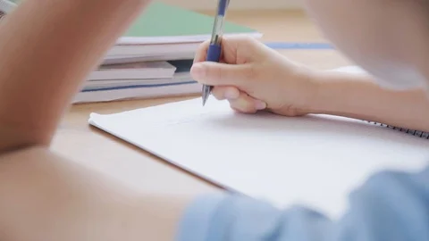 Kid hand doing mathematics homework tasks at home Video stock 128485018