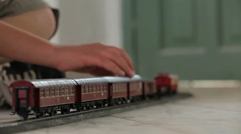 Kid hand moving Toy train backward Stock Footage 37558567