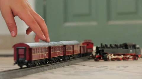 Kid hand moving Toy train back and forth Video stock 37558723