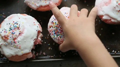 Kid hand pulling a cupcake from tray, video Video stock 78070393