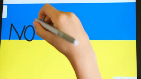 Kid hand while write no war sign on electronic device,stop war,ukraine invasion Stock Footage 201051622