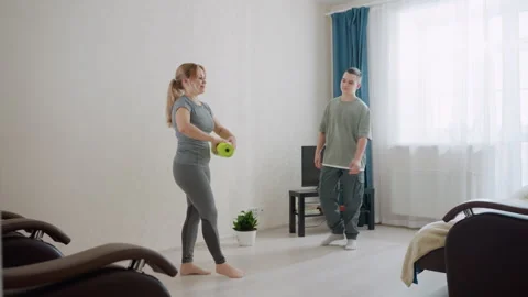 Kid Handing Exercise Mat to Mom for Workout Preparation Video stock 321091528