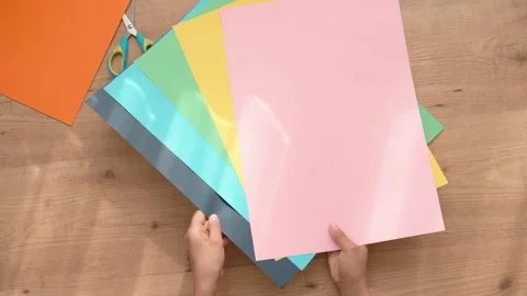 Kid hands with colored paper start doing school art craft project at home. Top Stock-Footage 134481629