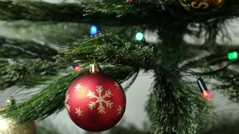 Kid hands hang ball on branch of Christmas tree. Festival mood. Positive emotion Stock Footage 219565280