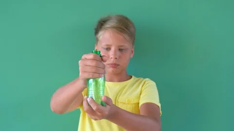 Kid hands holding one empty plastic bottle and crumpling it Stock Footage 120749758