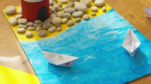 Kid hands make a lighthouse for school project at home. 4k video Stock Footage 134470107