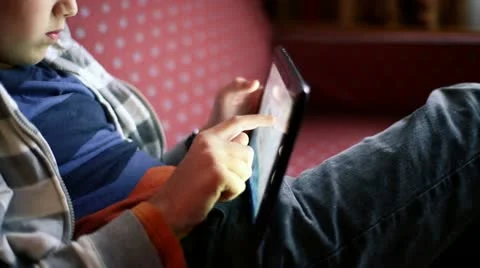 Kid hands playing games on tablet computer HD Stock Footage 12517288