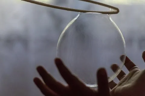 Kid hands on a soap balloon Stock Photos