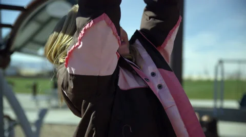 Kid hanging from monkey bars 2 4K Stock Footage 32395332