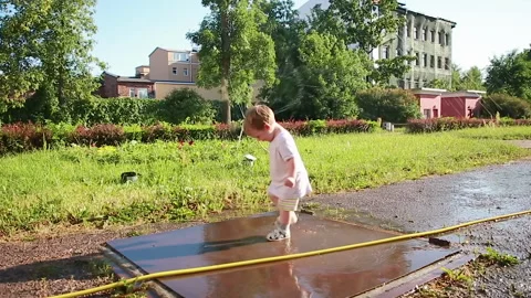 The kid is happy with puddles Stock Footage 157182117