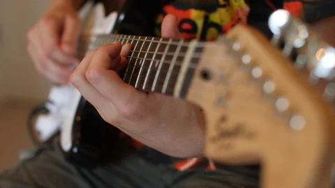Kid having fun and play electric guitar guitarist at home musician playing music Stockbeeldmateriaal 86122586