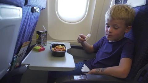 A kid having a meal on a flight Stock Footage 58509762