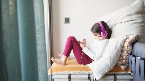 Kid with headset and mask watching the phone Stock-Footage 128966592