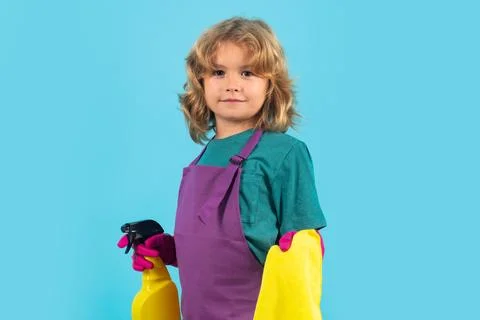 Kid helping with housework, cleaning. Studio portrait of child helping with 스톡 사진
