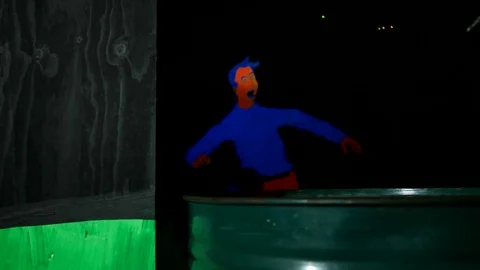 Kid hides behind a barrel and shoots a lasertag weapon Stock Footage 77356735