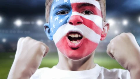 Kid with this his face painted withe the American flag and stadium as background Stock Footage 88182224