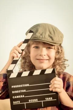 Kid holding clapper board in hands Stock Photos