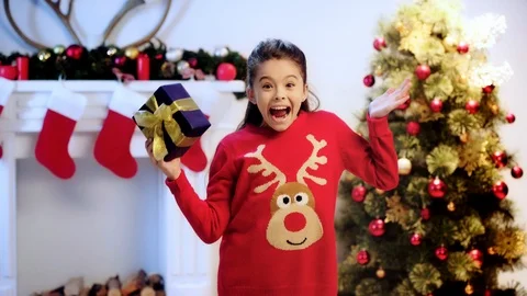 Kid holding gift and gesturing on christmas Stock Footage 114811746