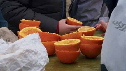 A kid holding half an orange Stock Footage 168182332