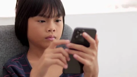 Kid holding phone Stock Footage 224431458