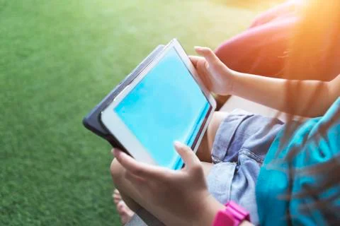 Kid holding a tablet with empty screen. Stock Photos
