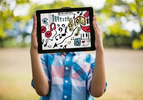 Kid holding tablet over face showing music doodles and white background 스톡 사진