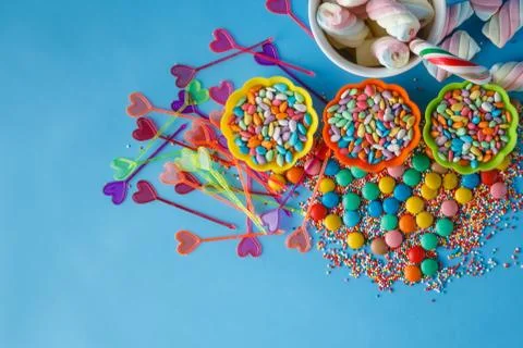 Kid holiday decoration. Colored candy on blue background Foto stock