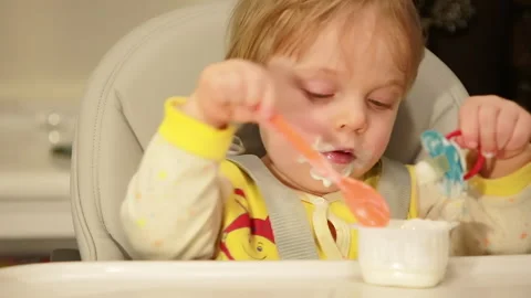 The kid at home eats cottage cheese Stock Footage 147179453